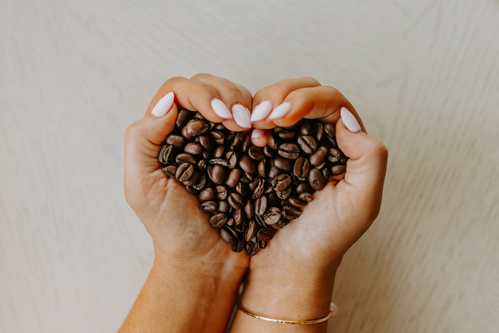 Coffee Beans in hands making a heart shape